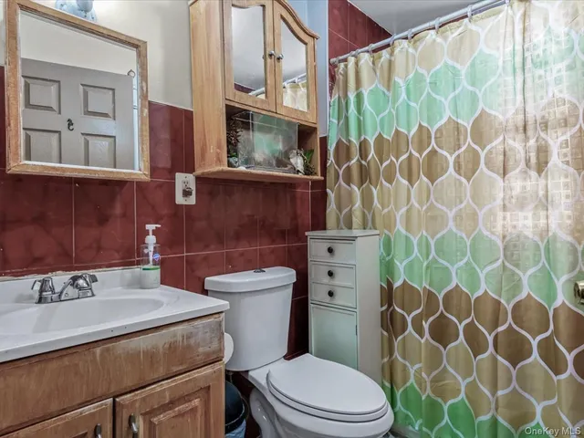 a bathroom with a toilet a sink and a shower