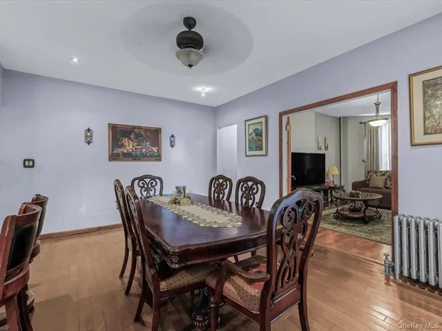 a view of a a dining room with furniture window and wooden floor