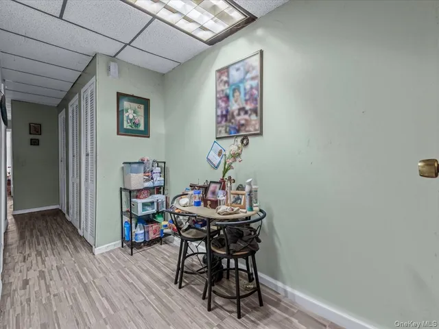 a dining room with furniture and wooden floor