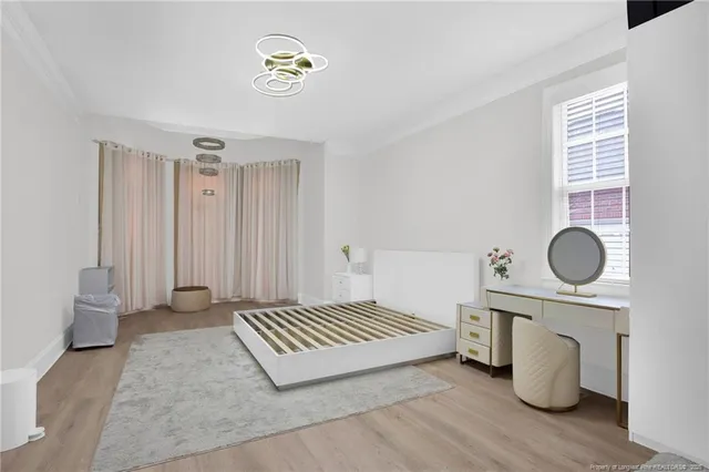 a view of a livingroom with wooden floor and a window