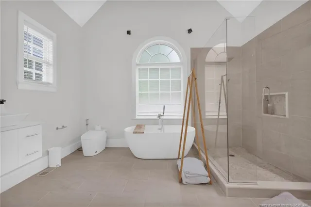 a spacious bathroom with a bathtub and a shower