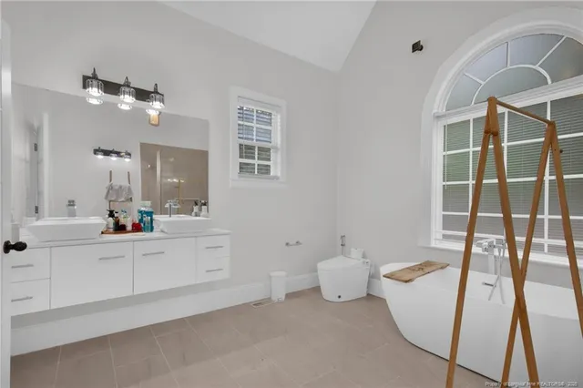 a bathroom with a sink mirror vanity and toilet