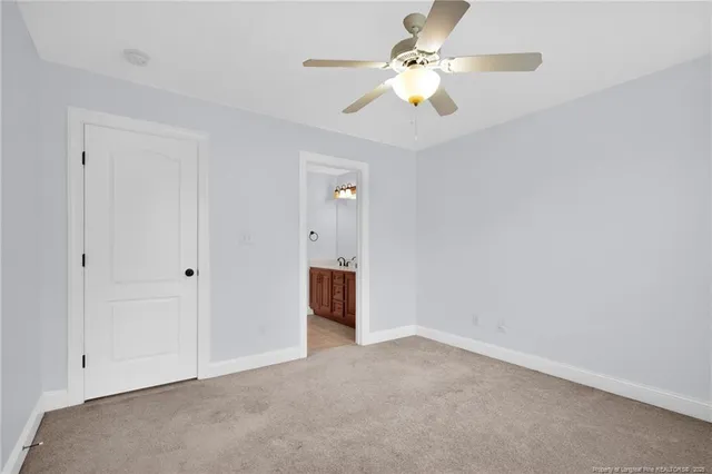 a view of an empty room with a ceiling fan