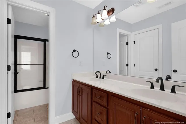 a bathroom with a double vanity sink and a mirror