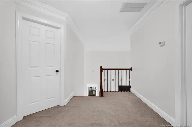 an empty room with a window and stairs