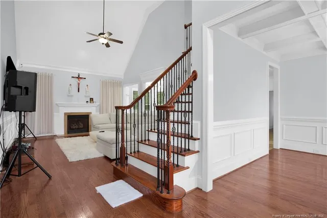 a view of a livingroom with furniture a fireplace chandeliers fan