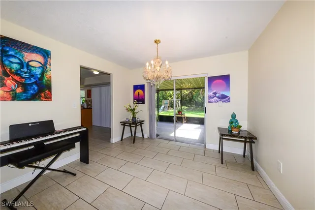a dining room with furniture and a chandelier