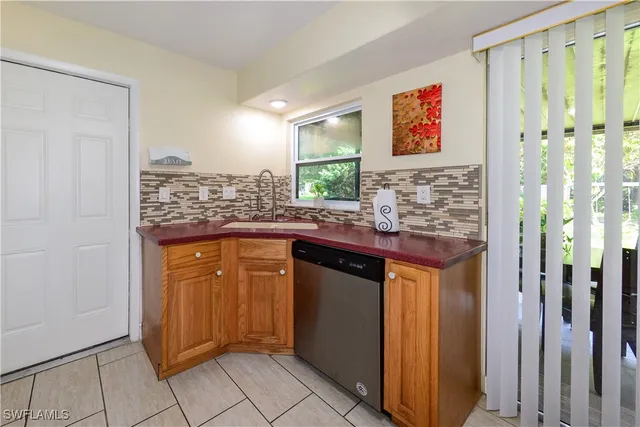 a kitchen with granite countertop cabinets and window