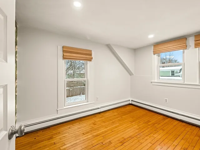 a view of a room with wooden floor and pool table