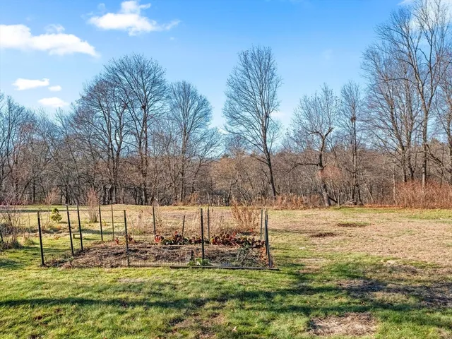 a view of a house with a yard and covered with snow