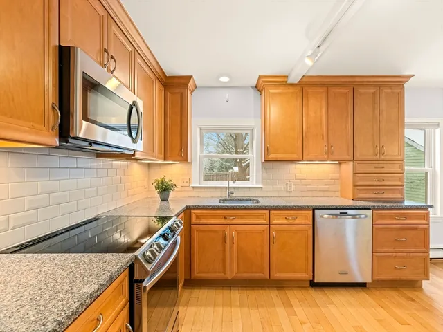 a kitchen with granite countertop a sink and a stove