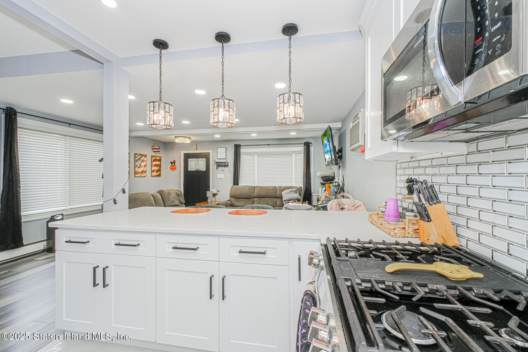 537 Annadale Road Staten Island, NY 10312 - Photo 11 of 27 a view of a kitchen with stainless steel appliances kitchen island granite countertop a stove a sink and a wooden floor