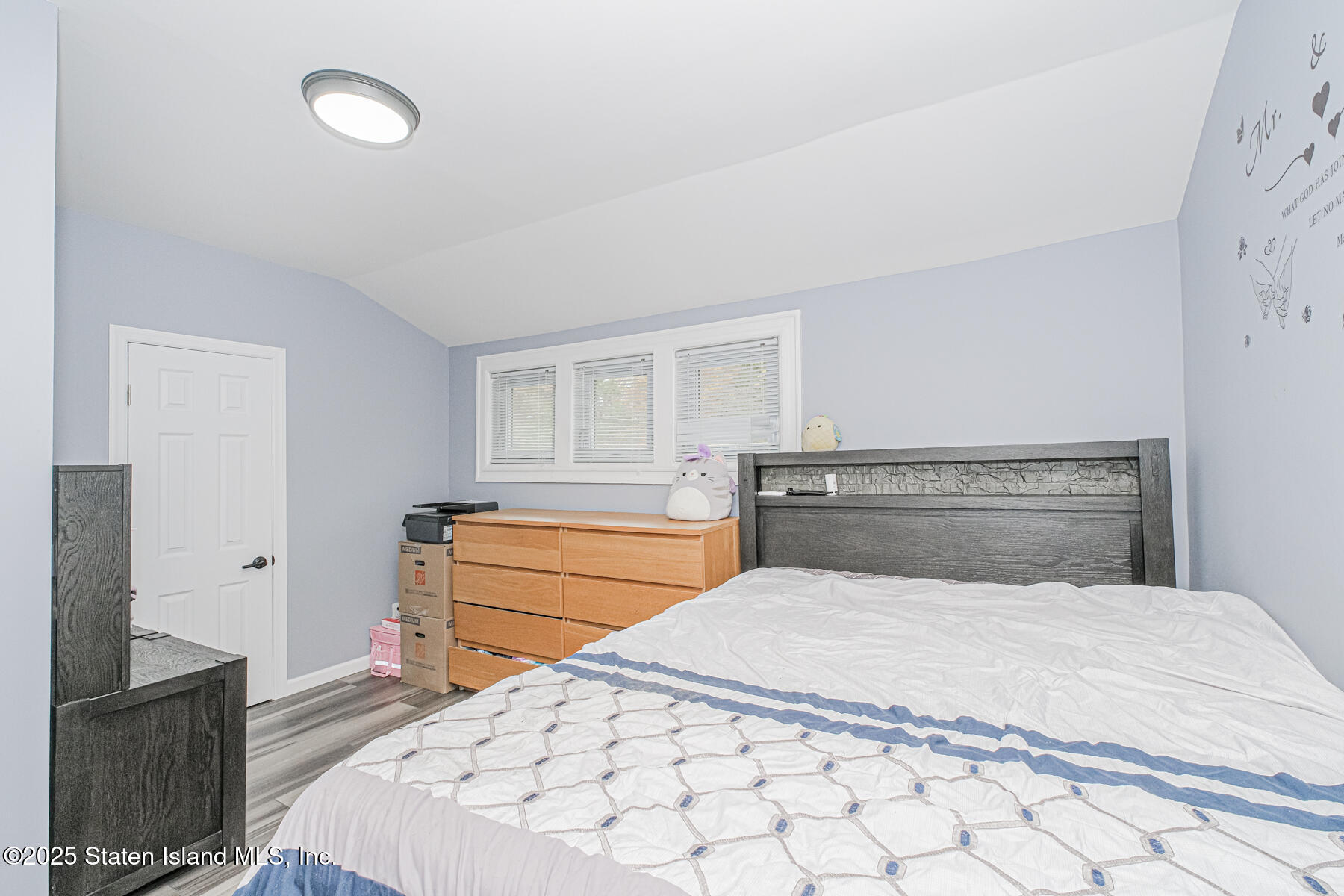 537 Annadale Road Staten Island, NY 10312 - Photo 15 of 27 a bedroom with a large bed and a flat tv screen on dresser