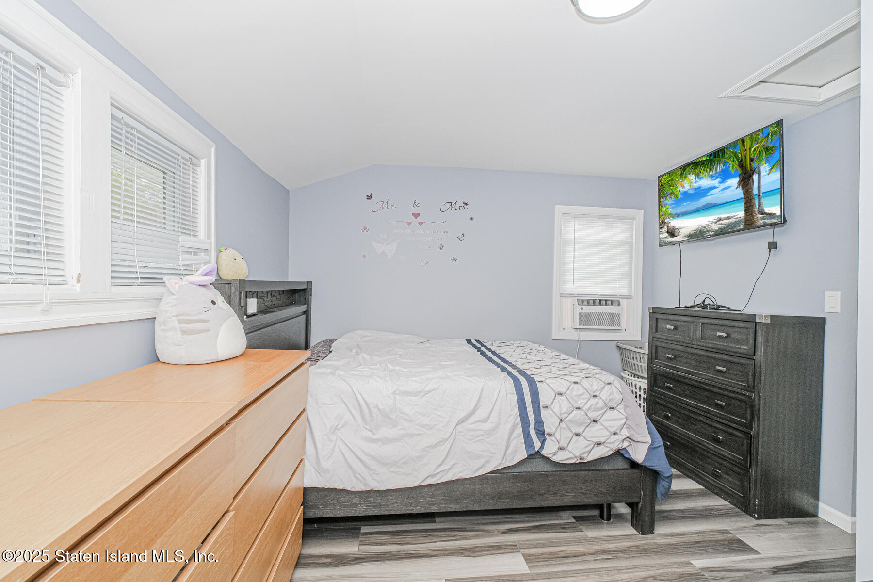 537 Annadale Road Staten Island, NY 10312 - Photo 16 of 27 a bedroom with a bed and dresser with mirror