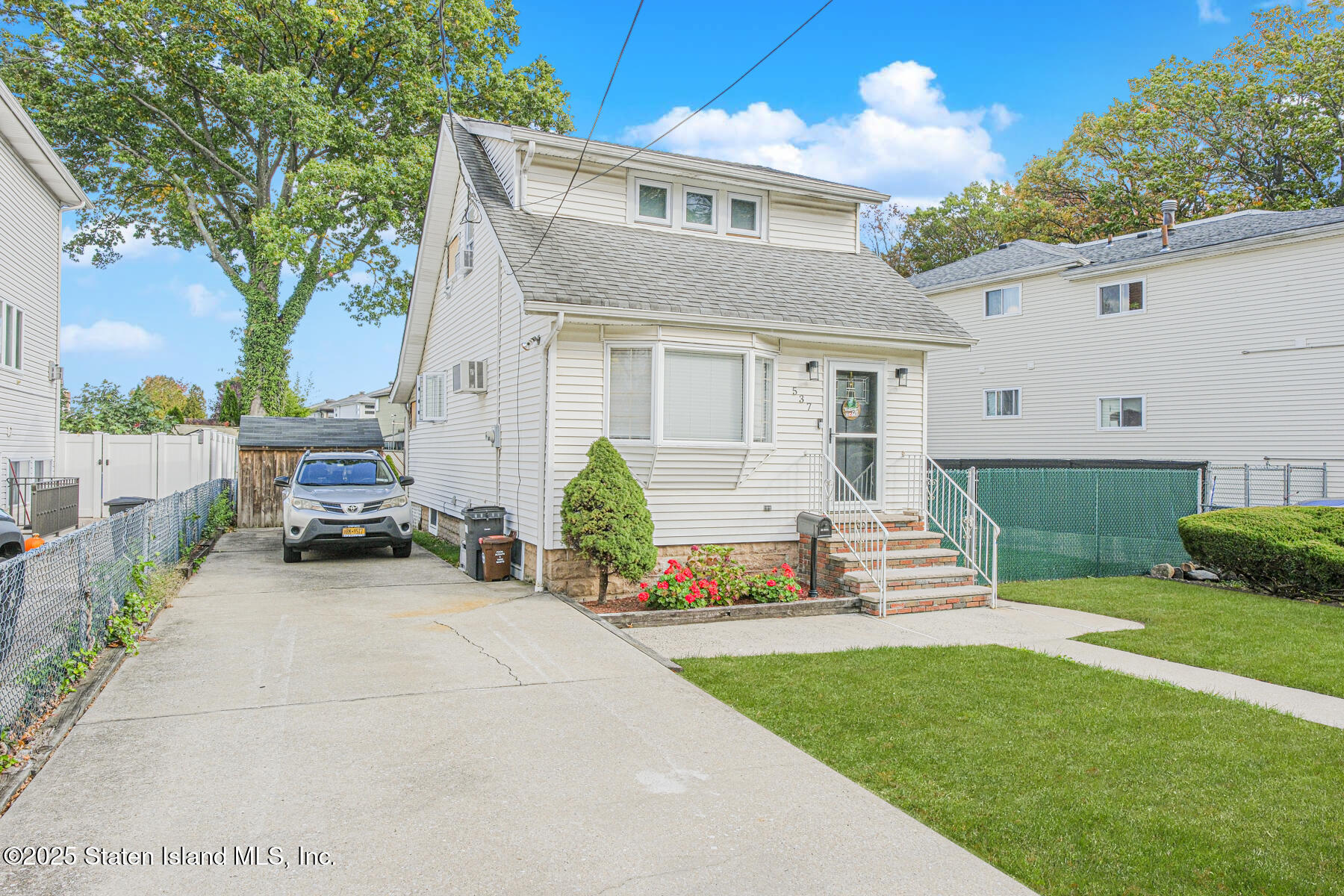 537 Annadale Road Staten Island, NY 10312 - Photo 2 of 27 a front view of a house with a yard and outdoor seating