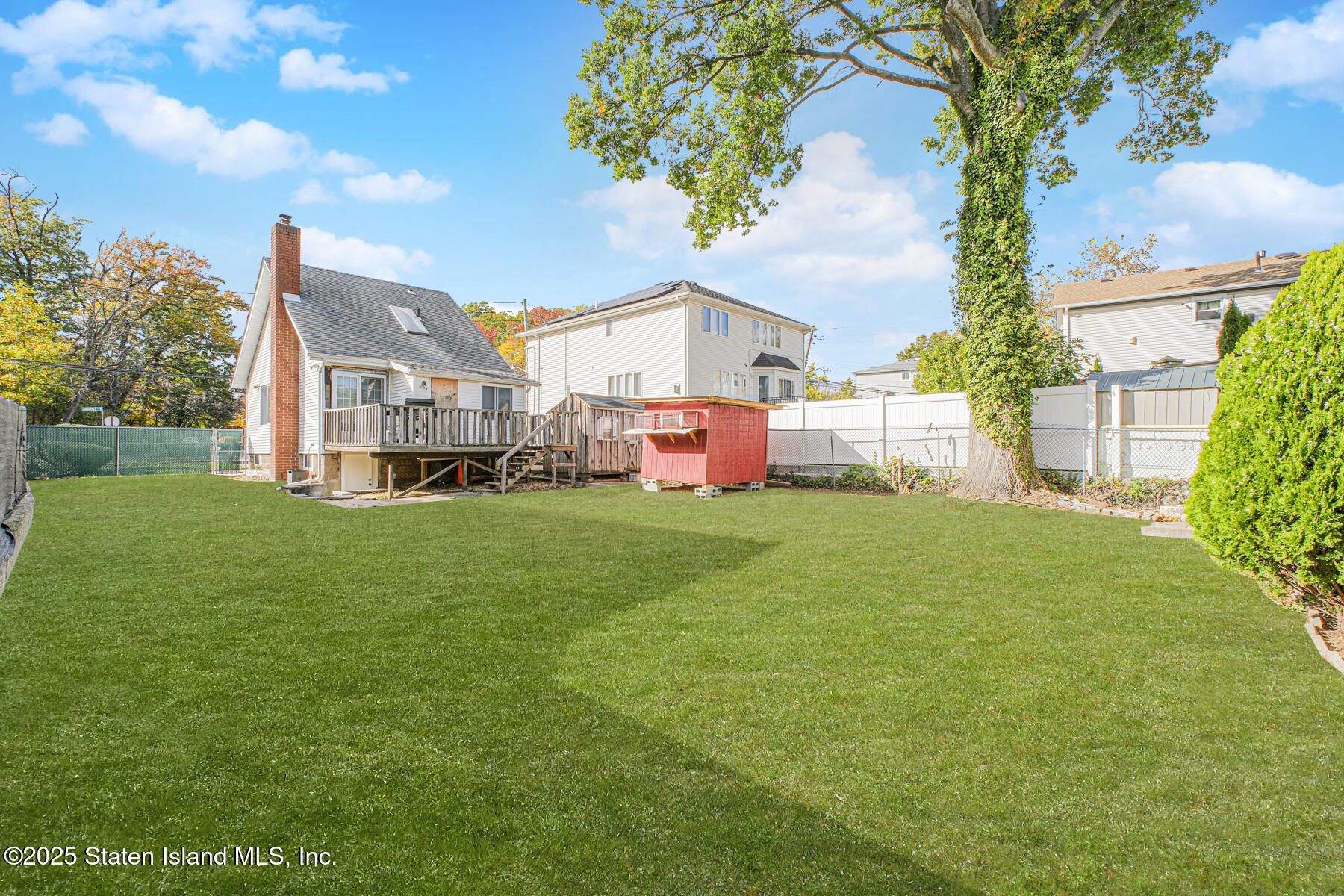 537 Annadale Road Staten Island, NY 10312 - Photo 26 of 27 a front view of a house with a big yard and large trees
