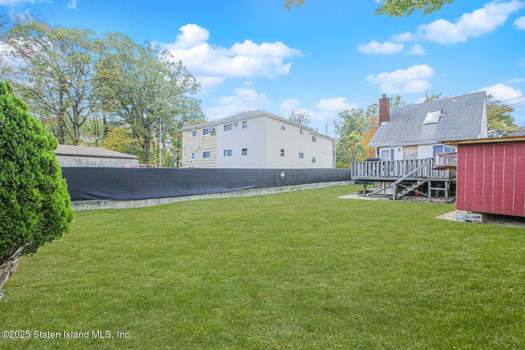 537 Annadale Road Staten Island, NY 10312 - Photo 27 of 27 a view of an house with backyard and a tree