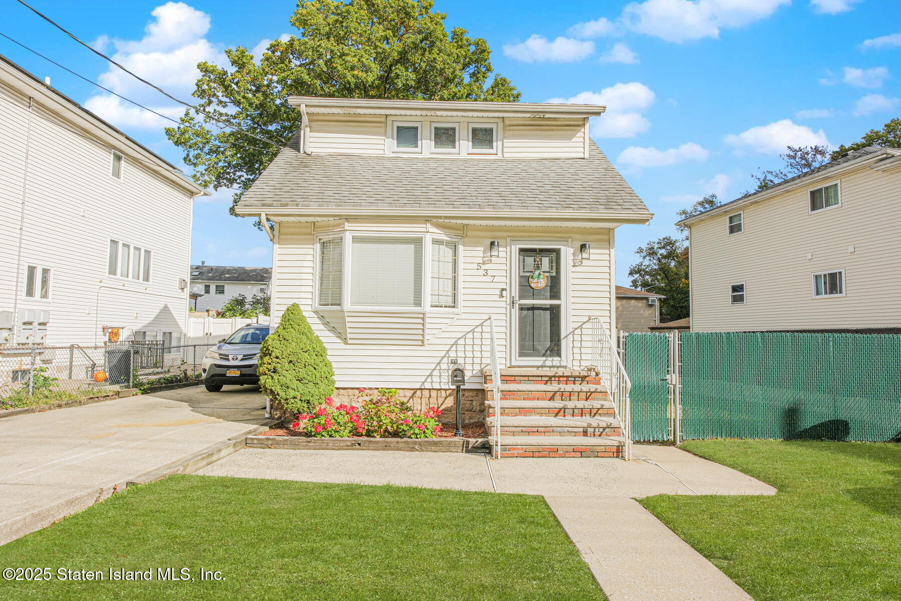 537 Annadale Road Staten Island, NY 10312 - Photo 3 of 27 a front view of a house with a yard and potted plants