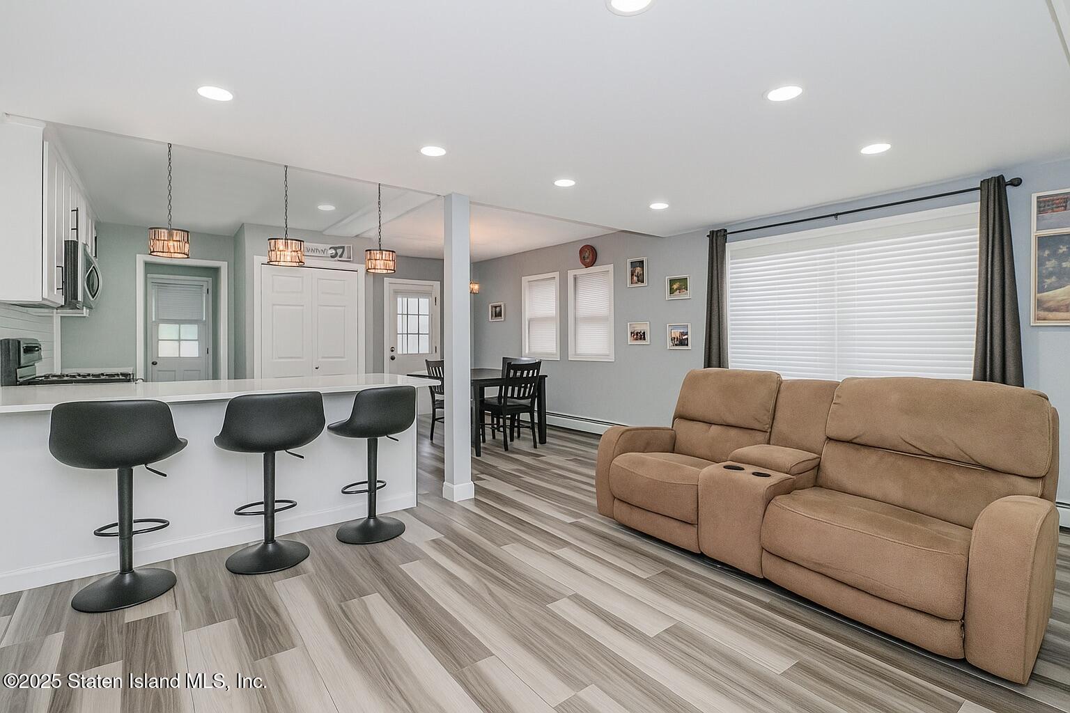 537 Annadale Road Staten Island, NY 10312 - Photo 6 of 27 a living room with furniture and a chandelier