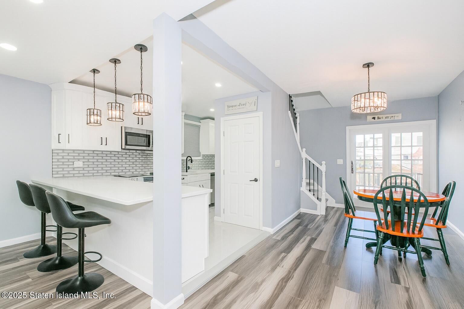 537 Annadale Road Staten Island, NY 10312 - Photo 9 of 27 a view of a dining room with furniture and wooden floor