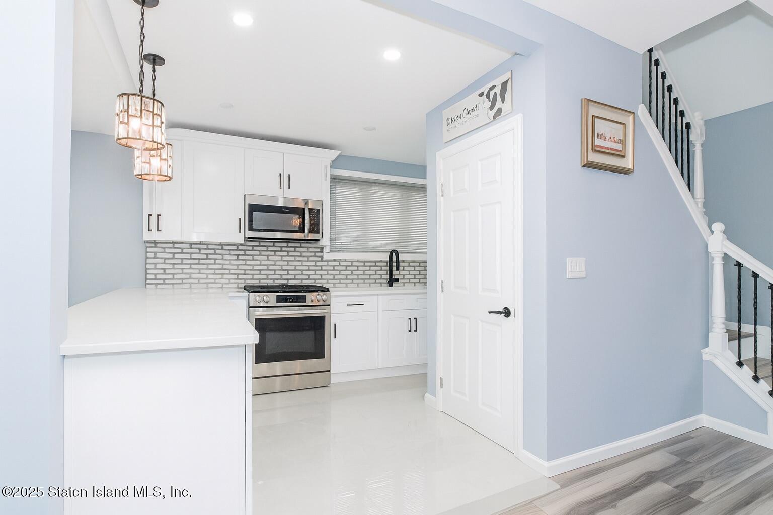 537 Annadale Road Staten Island, NY 10312 - Photo 10 of 27 a kitchen with stainless steel appliances a refrigerator sink and stove
