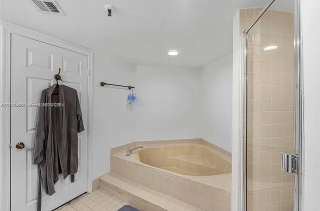 a bathroom with a tub and a shower