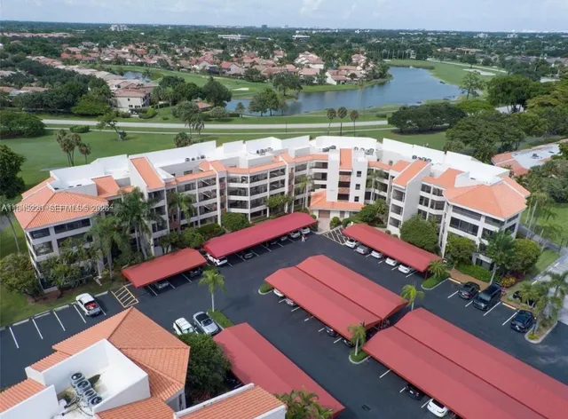an aerial view of residential houses with outdoor space and lake view