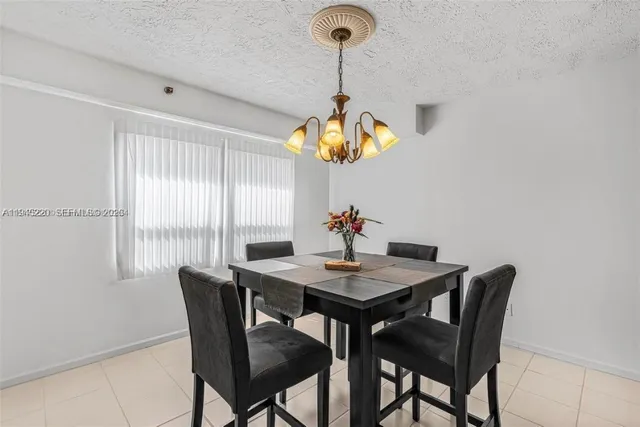 a view of a dining room with a table and chairs