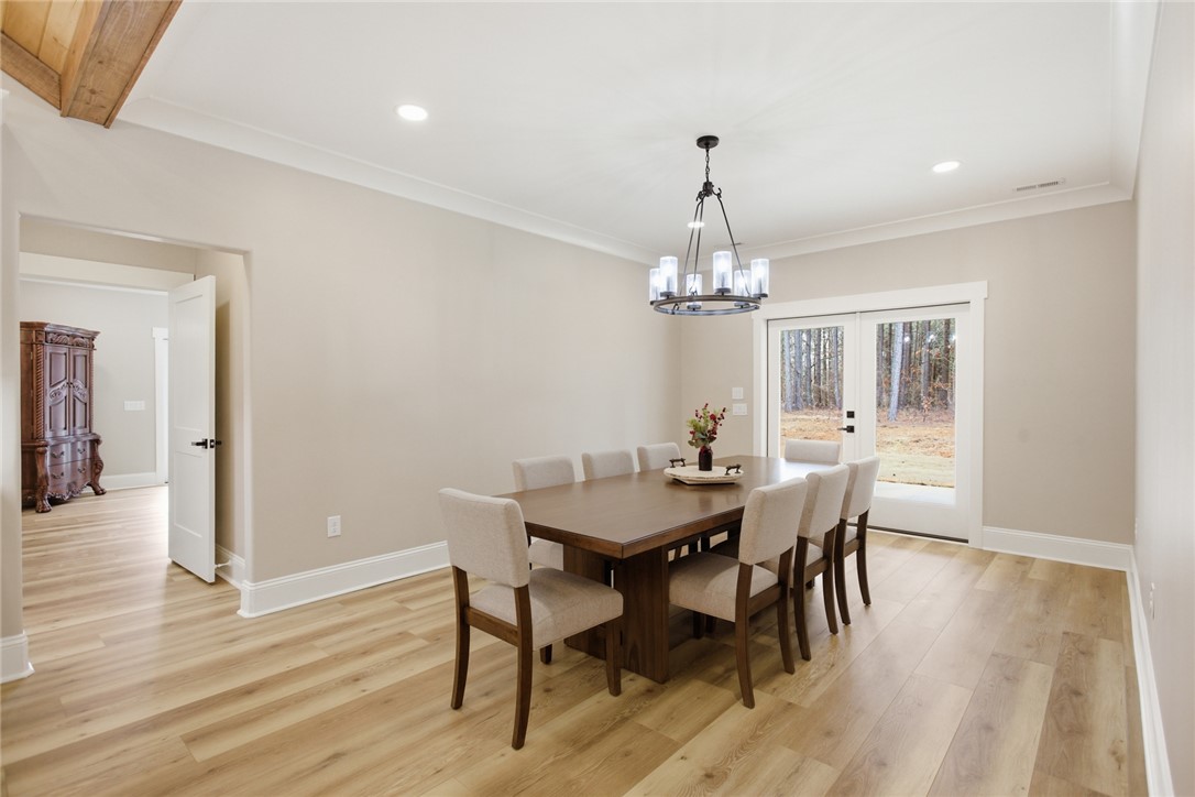 147 McAlister Road West Union, SC 29696 - Photo 11 of 49 This bright dining room features an elegant chandelier and durable wood flooring.