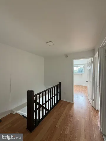 a view of hallway with wooden floor