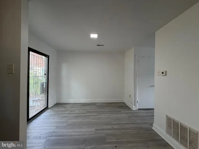 a view of room with window and wooden floor