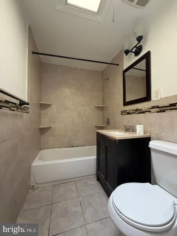 a bathroom with a sink a toilet and bathtub