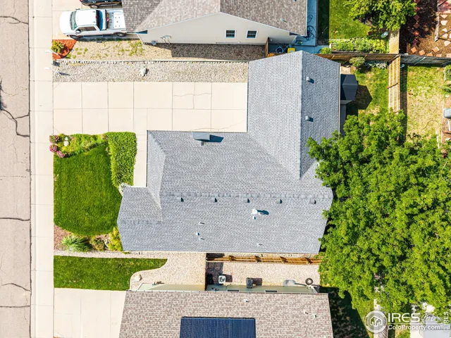 an aerial view of a house with a yard