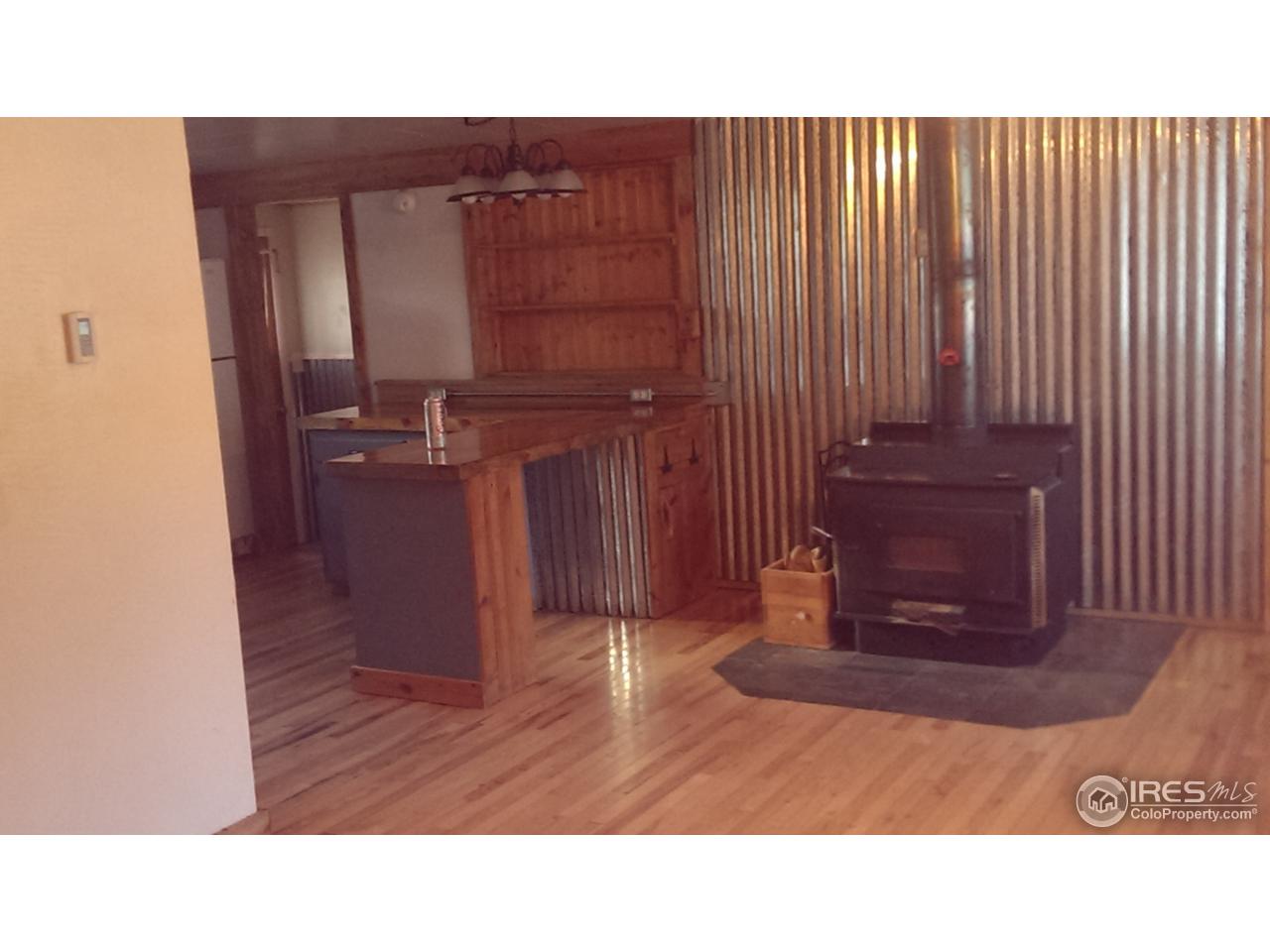227 Onawa Road Red Feather Lakes, CO 80545 - Photo 20 of 37 Wood Stove And Kitchen