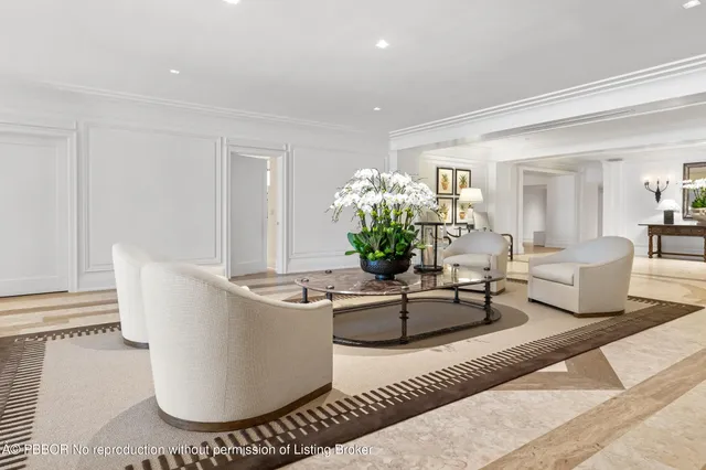 a living room with furniture and flowers