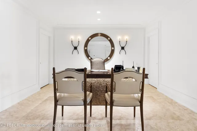 a view of a dining room with furniture and a mirror