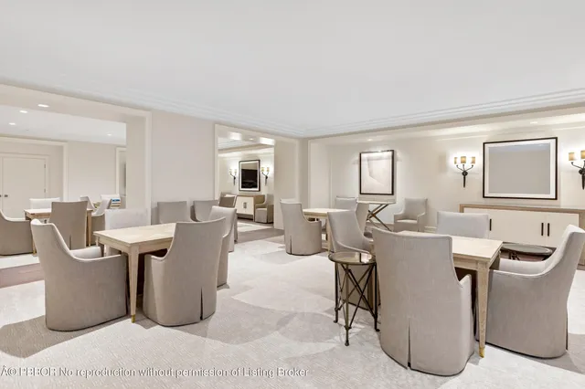 a living room with couches and kitchen view with wooden floor