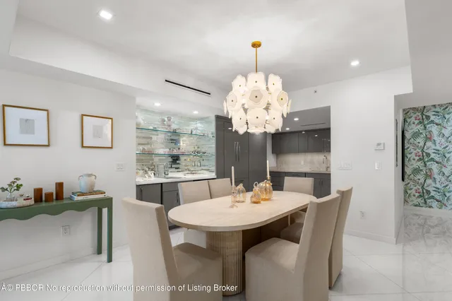 a view of a dining room with furniture a chandelier and wooden floor