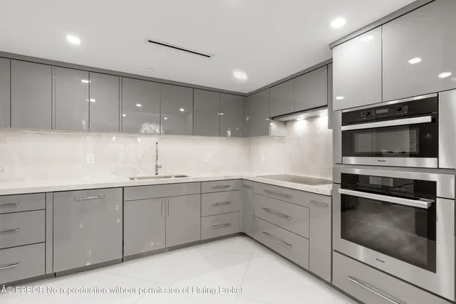 a kitchen with a sink and stainless steel appliances