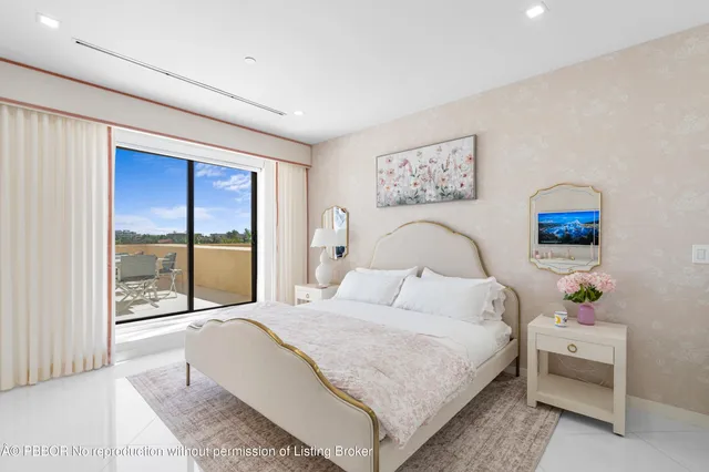 a bedroom with a bed and large window