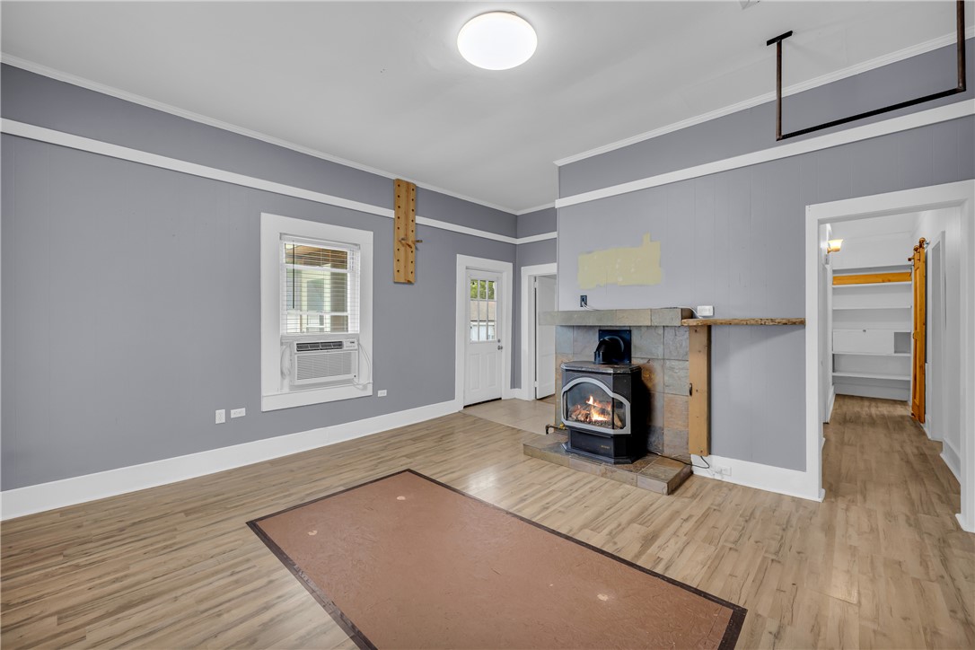 Wood flooring and a classic fireplace insert anchor this comfortable living area.