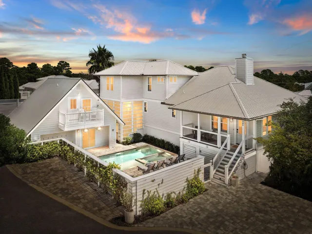 a view of house with yard and sitting area