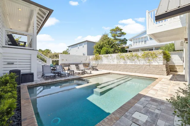 a living room with furniture or wooden floor and a flat screen tv