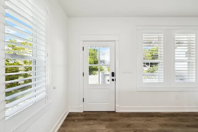 a kitchen with stainless steel appliances granite countertop a dining table and chairs