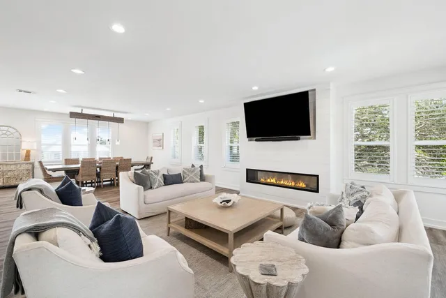 a kitchen with stainless steel appliances kitchen island granite countertop a table chairs and a refrigerator