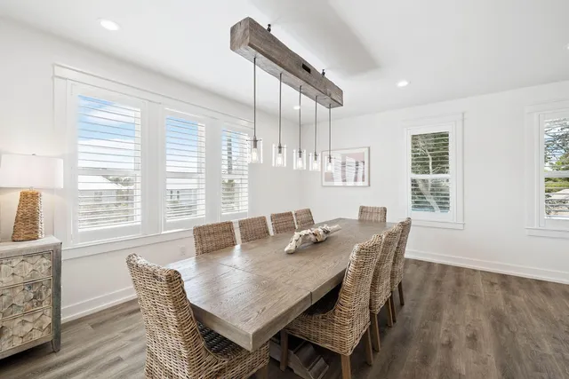 a large kitchen with kitchen island a stove a sink a center island and windows