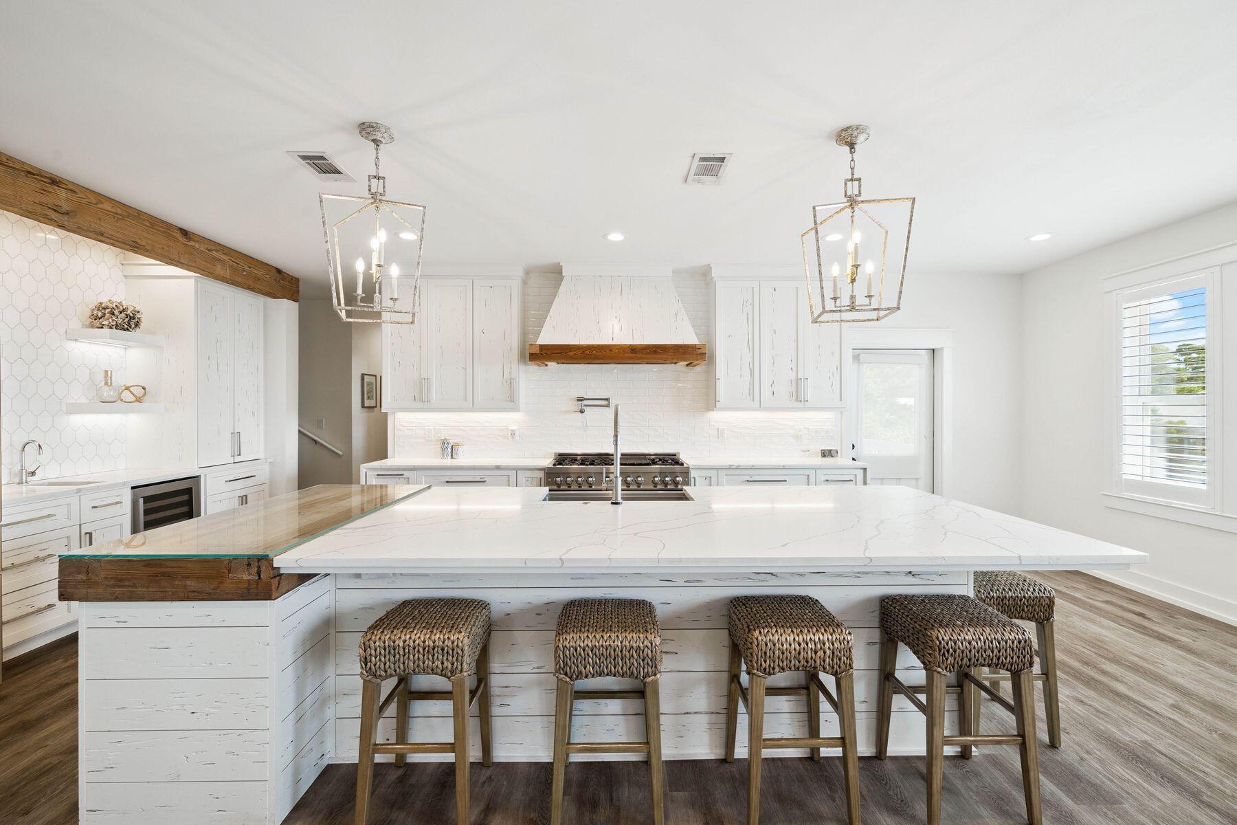 1984 South Co Highway 83 Santa Rosa Beach, FL 32459 - Photo 24 of 70 a kitchen with stainless steel appliances granite countertop a dining table and chairs