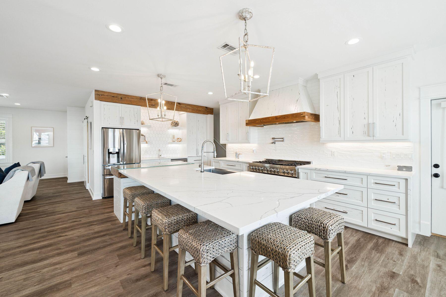 1984 South Co Highway 83 Santa Rosa Beach, FL 32459 - Photo 25 of 70 a kitchen with stainless steel appliances kitchen island granite countertop a table chairs and a refrigerator
