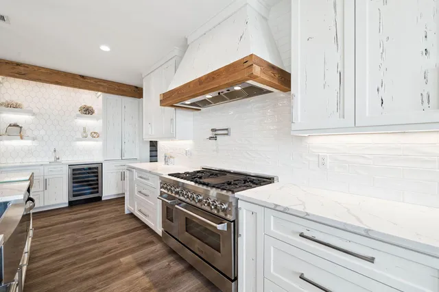 a spacious bedroom with a bed and a flat screen tv