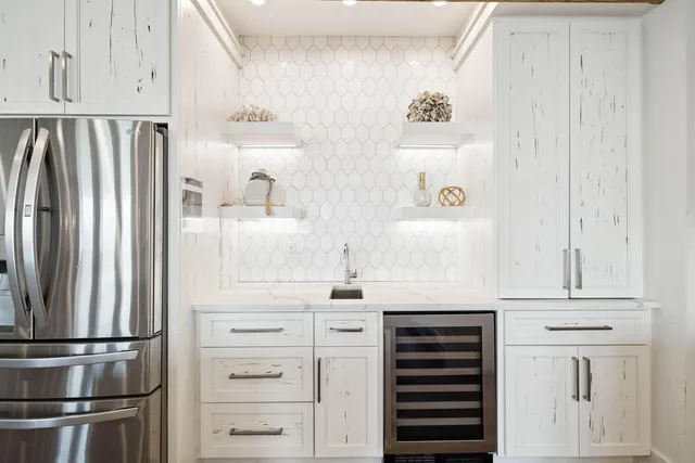 a white bath tub sitting in a bathroom next to a window